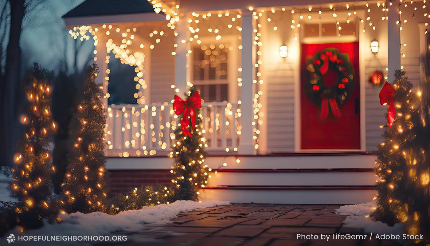 White house with red door decorated with with holiday lights