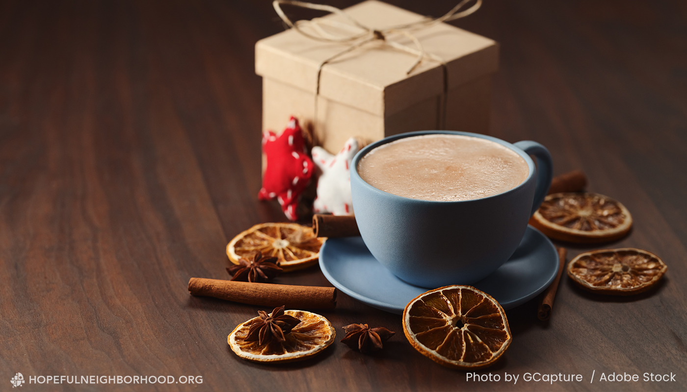 2025-12-blog_hnp_gifts2 cup of coffee, dried oranges and a small gift box to depict gifts to build connection